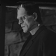 Boris Karloff in his Frankenstein make-up stands in profile in a scene from the film.